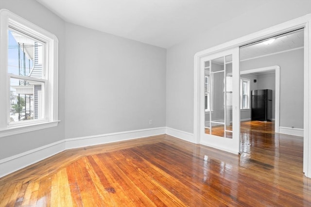 570 William St, Fall River, MA 02721 - spare room featuring plenty of natural light, wood finished floors, and baseboards
