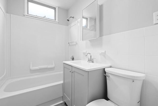570 William St, Fall River, MA 02721 - bathroom with toilet, vanity, bathtub / shower combination, and tile walls