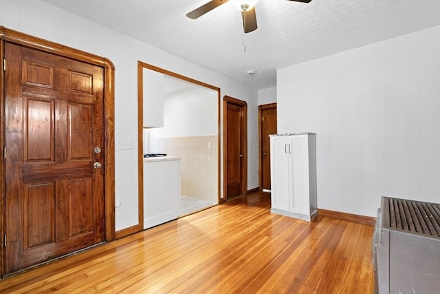 570 William St, Fall River, MA 02721 - empty room featuring light wood-style floors, a ceiling fan, and baseboards