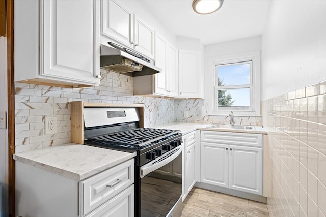 570 William St, Fall River, MA 02721 - kitchen featuring stainless steel gas range oven, a sink, under cabinet range hood, and white cabinetry