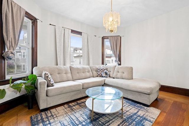 570 William St, Fall River, MA 02721 - living area featuring a chandelier, wood finished floors, and baseboards