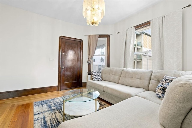 570 William St, Fall River, MA 02721 - living room featuring wood finished floors, baseboards, and a chandelier