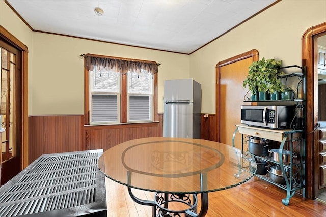 570 William St, Fall River, MA 02721 - dining room with wainscoting, wood finished floors, ornamental molding, and wood walls