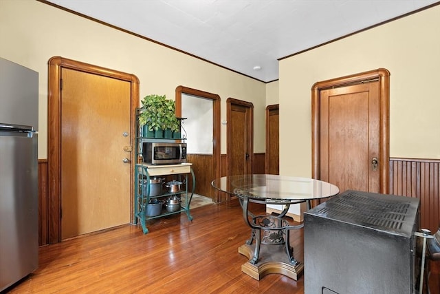570 William St, Fall River, MA 02721 - dining room with wainscoting, wood finished floors, wood walls, and ornamental molding