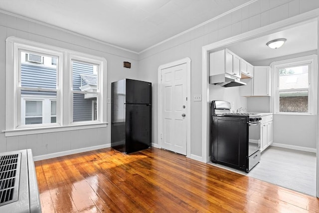 570 William St, Fall River, MA 02721 - kitchen featuring black appliances, under cabinet range hood, crown molding, light wood-style floors, and white cabinets
