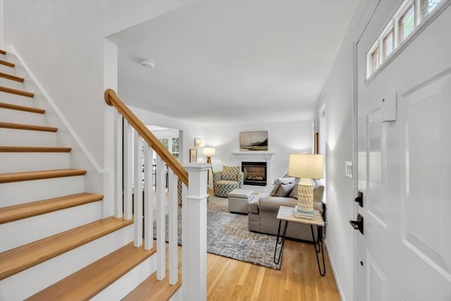 13 Pickerel Way, Sandwich, MA 02644 - living area with stairs, a fireplace, and light wood finished floors