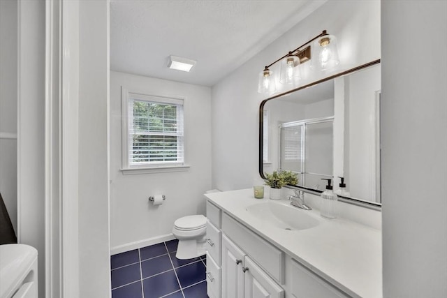 13 Pickerel Way, Sandwich, MA 02644 - bathroom featuring toilet, vanity, a stall shower, tile patterned floors, and baseboards