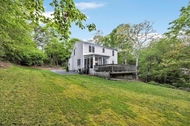 13 Pickerel Way, Sandwich, MA 02644 - back of property featuring a lawn, a wooden deck, and a sunroom