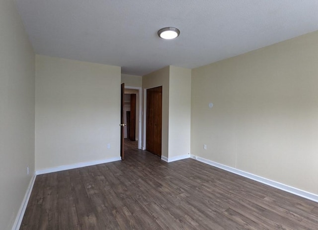 empty room featuring dark hardwood / wood-style floors