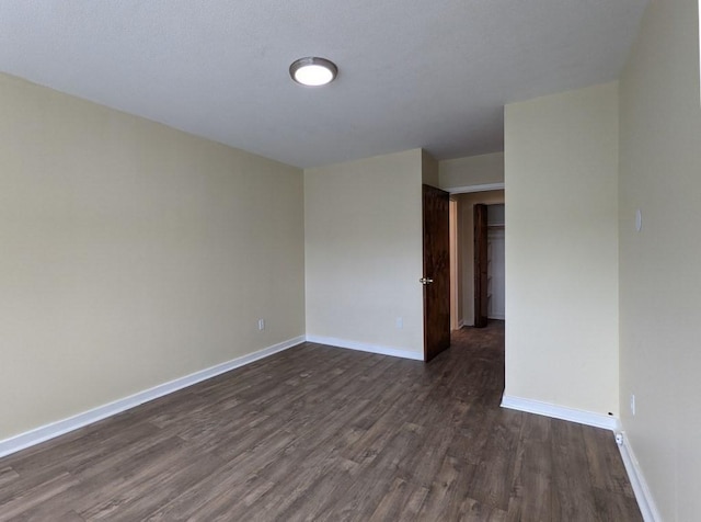 spare room featuring dark hardwood / wood-style floors