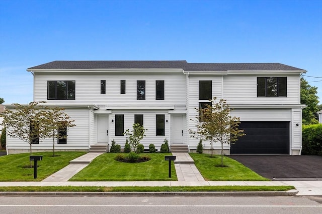 view of front facade featuring a garage and a front lawn