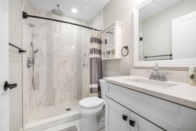 bathroom with vanity, a stall shower, and toilet