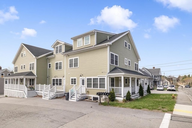 back of property with a porch and a residential view
