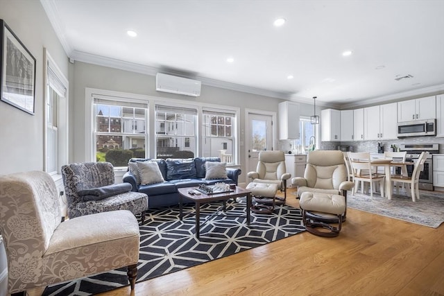 living area featuring crown molding, recessed lighting, a wall mounted air conditioner, and wood finished floors