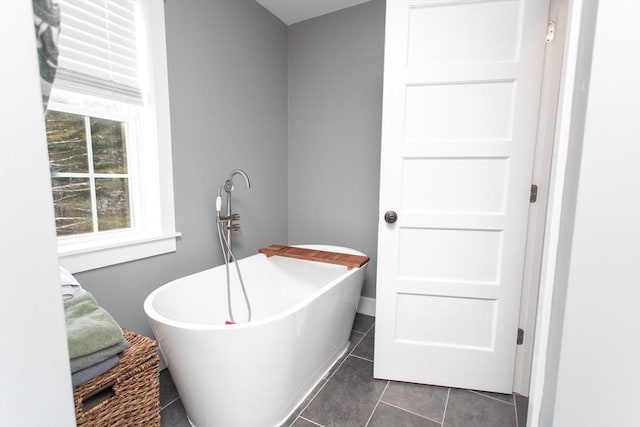 full bathroom featuring tile patterned flooring and a soaking tub