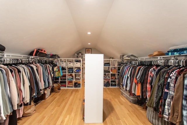 walk in closet featuring wood finished floors and vaulted ceiling