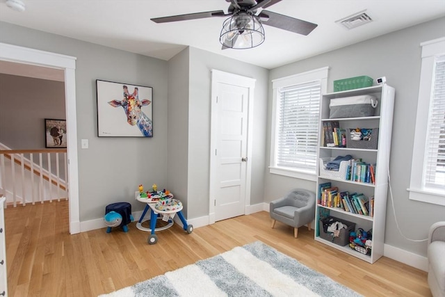 rec room featuring visible vents, baseboards, and wood finished floors