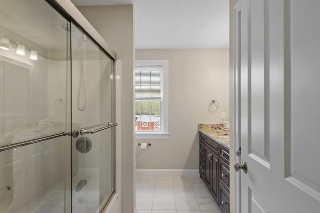 full bathroom featuring marble finish floors, an enclosed shower, baseboards, and vanity