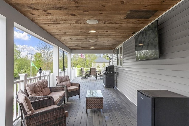 wooden terrace featuring an outdoor living space, outdoor dining area, and area for grilling