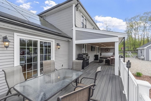 wooden deck featuring outdoor dining space, an outdoor hangout area, and area for grilling