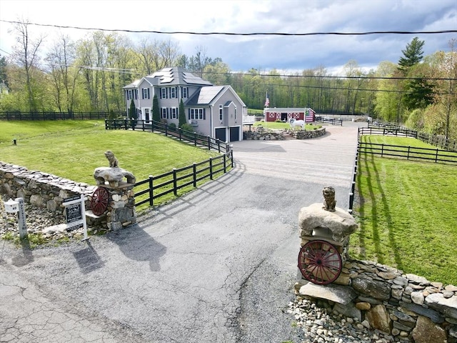 view of front of house featuring asphalt driveway and an attached garage