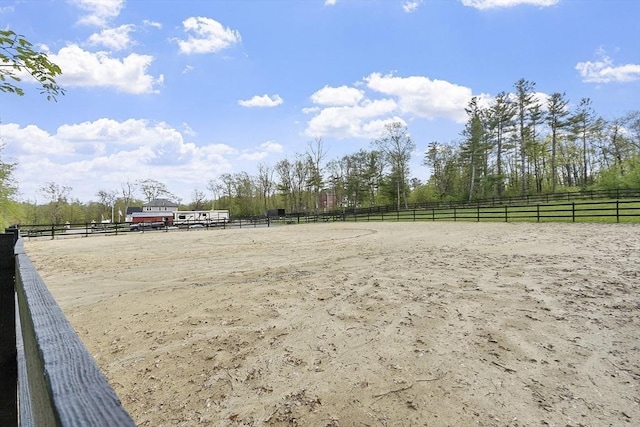 surrounding community with an enclosed riding area, a view of rural / pastoral area, and fence