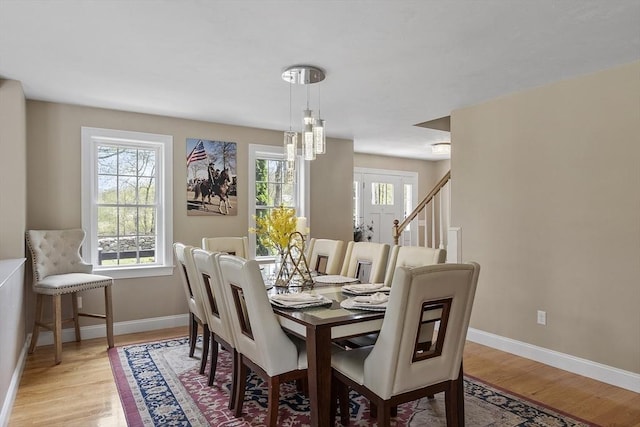 dining area with light wood finished floors and baseboards