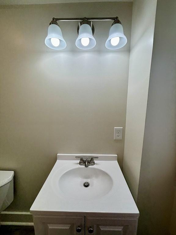 bathroom featuring toilet and vanity