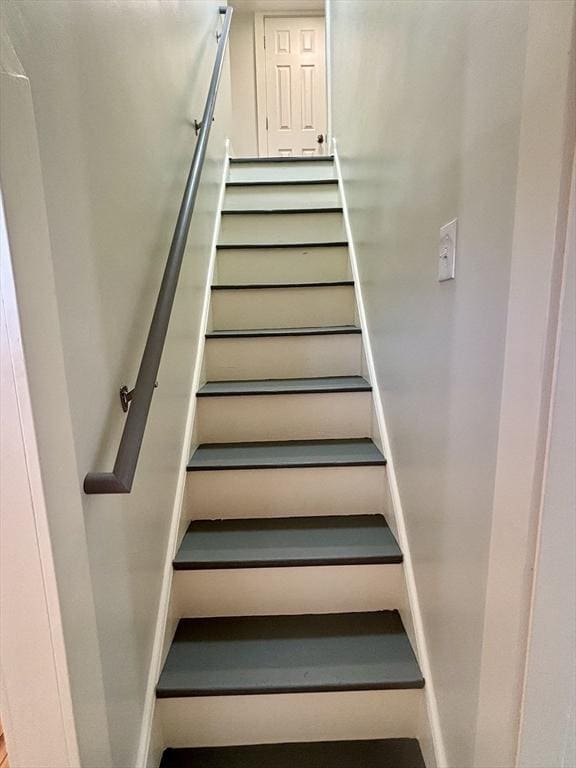 staircase featuring baseboards