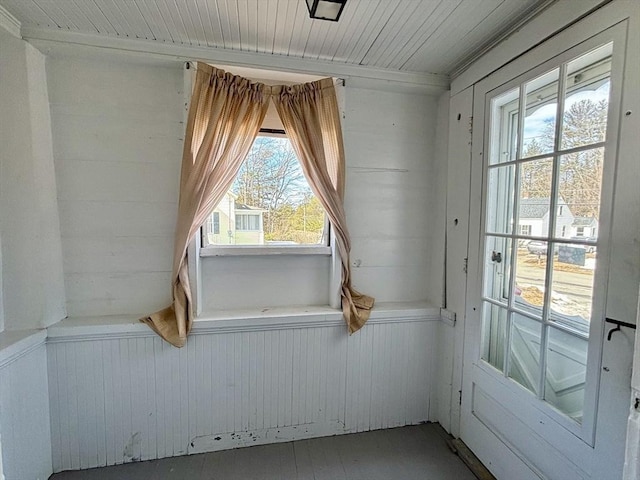 interior space featuring wooden ceiling and wood walls