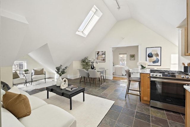 living area featuring lofted ceiling with skylight