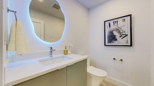 140 Columbia St Unit 2, Brookline, MA 02446 - bathroom featuring toilet, vanity, and baseboards