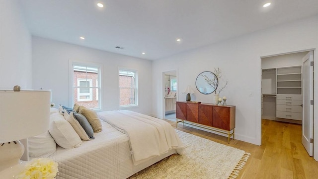 140 Columbia St Unit 2, Brookline, MA 02446 - bedroom featuring a walk in closet, light wood-style flooring, recessed lighting, baseboards, and a closet