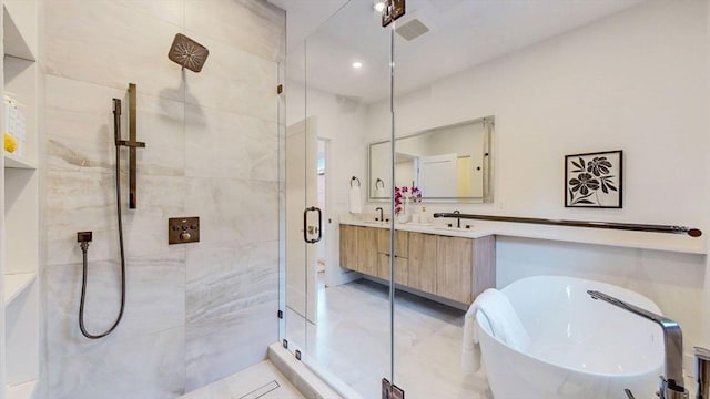 140 Columbia St Unit 2, Brookline, MA 02446 - bathroom with a stall shower, a soaking tub, vanity, and recessed lighting