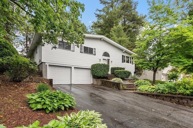 12 Debra Ln, Framingham, MA 01701 - split foyer home with an attached garage and driveway