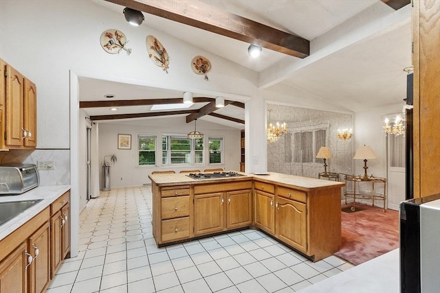 12 Debra Ln, Framingham, MA 01701 - kitchen with a chandelier, stainless steel gas cooktop, light countertops, light tile patterned floors, and brown cabinetry
