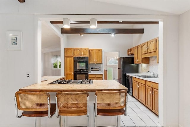 12 Debra Ln, Framingham, MA 01701 - kitchen with a sink, light countertops, backsplash, black appliances, and light tile patterned floors
