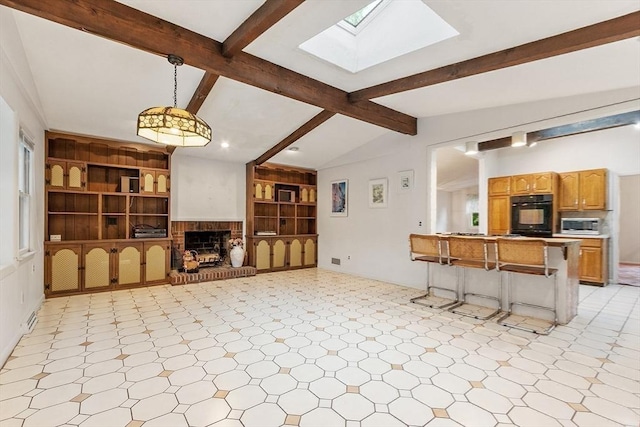 12 Debra Ln, Framingham, MA 01701 - living area with a skylight, light flooring, a brick fireplace, and built in shelves