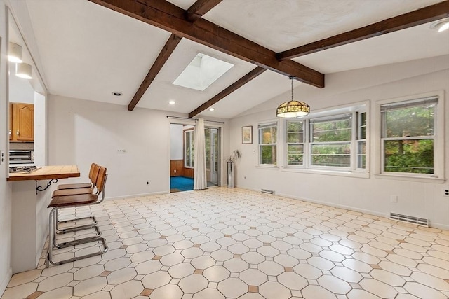 12 Debra Ln, Framingham, MA 01701 - kitchen featuring healthy amount of natural light, a breakfast bar, open floor plan, recessed lighting, and a skylight