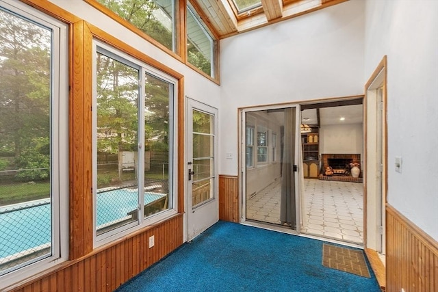 12 Debra Ln, Framingham, MA 01701 - unfurnished sunroom featuring a wainscoted wall, a skylight, healthy amount of natural light, wooden walls, and carpet