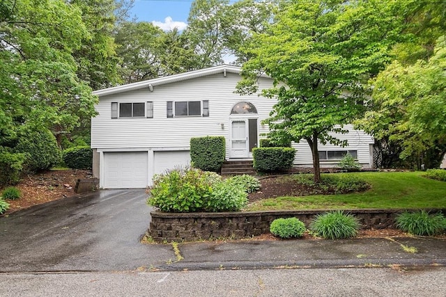 12 Debra Ln, Framingham, MA 01701 - split foyer home featuring an attached garage and asphalt driveway