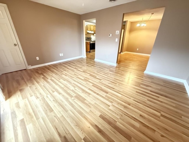 58 Randolph Dr Unit 58, Tewksbury, MA 01876 - spare room featuring light wood-style flooring and a chandelier