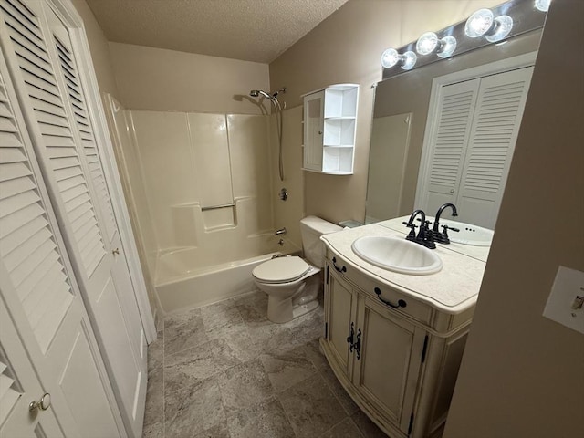 58 Randolph Dr Unit 58, Tewksbury, MA 01876 - bathroom with a closet, a textured ceiling, vanity, washtub / shower combination, and stone finish floors