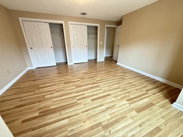 58 Randolph Dr Unit 58, Tewksbury, MA 01876 - unfurnished bedroom with light wood-style floors and two closets