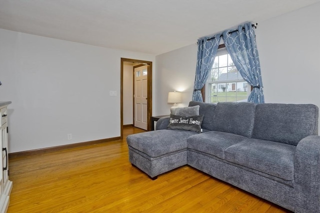 living room featuring light wood-style floors and baseboards