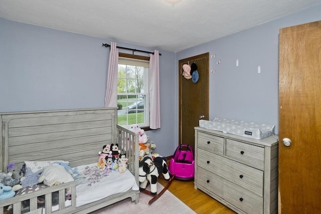 bedroom with light wood finished floors