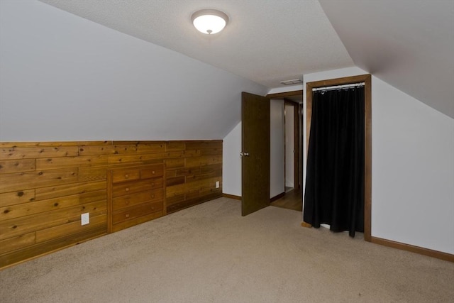 bonus room featuring baseboards, visible vents, carpet flooring, and lofted ceiling