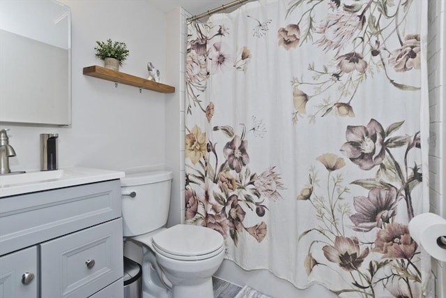 bathroom with vanity, shower / bathtub combination with curtain, and toilet