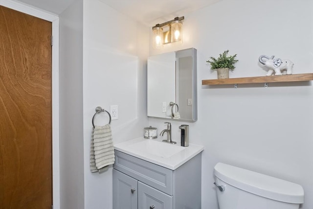 bathroom featuring vanity and toilet