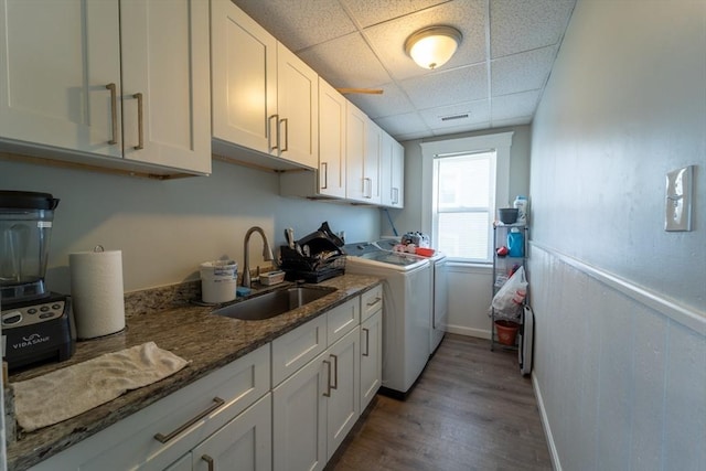 kitchen featuring white cabinets, independent washer and dryer, sink, and a paneled ceiling